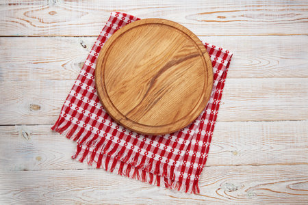 Empty pizza board and canvas tablecloth on white wooden deckの写真素材