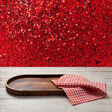 Pizza board with a napkin on wooden table. top view mockup. Festive sparkling red backgroundの写真素材