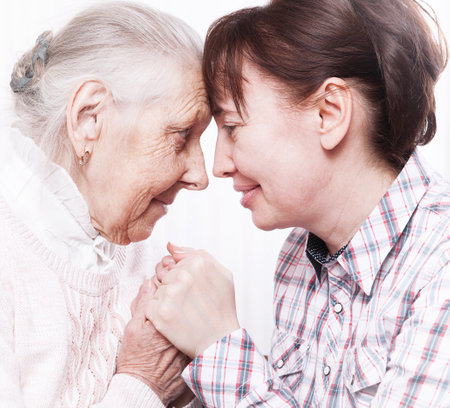 Care of senior woman at home sitting on the couchの写真素材