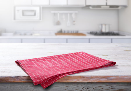 Wooden table with red napkin closeup. Kitchen background.の写真素材