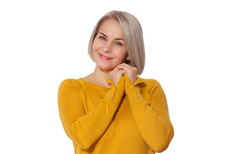Attractive Middle Aged Woman Smiles emotionally posing in studio on white backgroundの写真素材