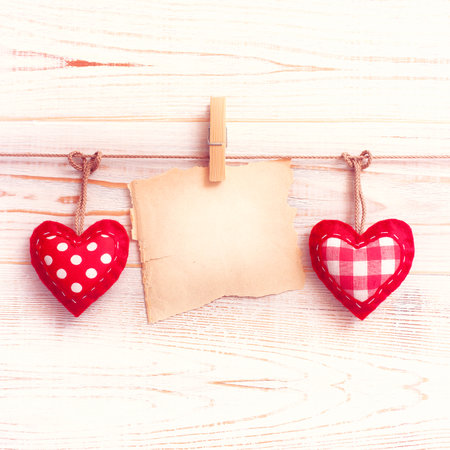 Blank sheet, a note, a torn sheet of paper and vintage red hearts hanging on garland. Valentines day conceptの写真素材