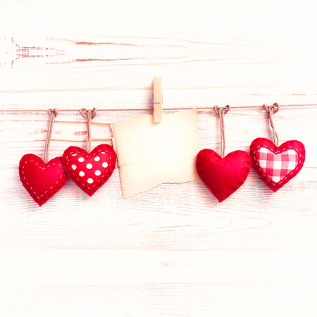 Blank sheet, note, torn sheet of paper and vintage red hearts hanging on garland. valentines day conceptの写真素材