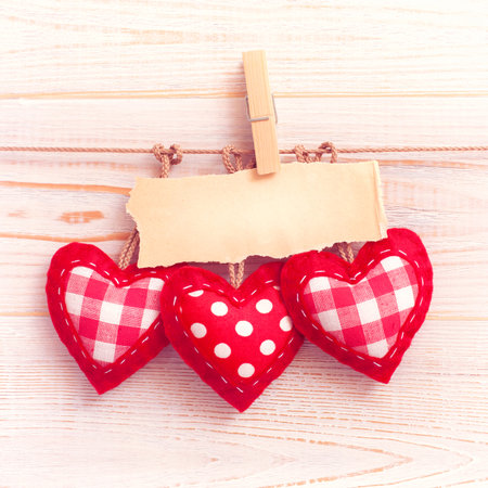 Blank sheet, note, torn sheet of paper and vintage red hearts hanging on garland. valentines day conceptの写真素材