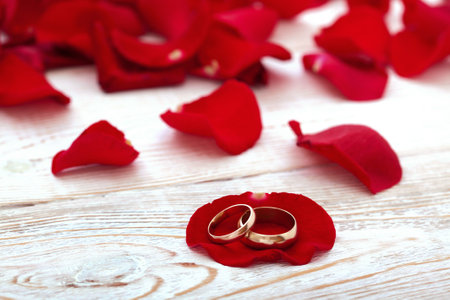 Wedding rings and wedding bouquet of red roses.の写真素材
