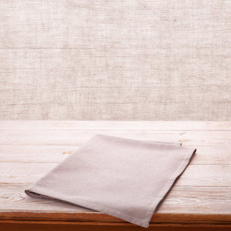 Make your product stand out with this eye-catching napkin mockup, showcasing your design against a natural wood grain. Kitchen rustic background.の写真素材