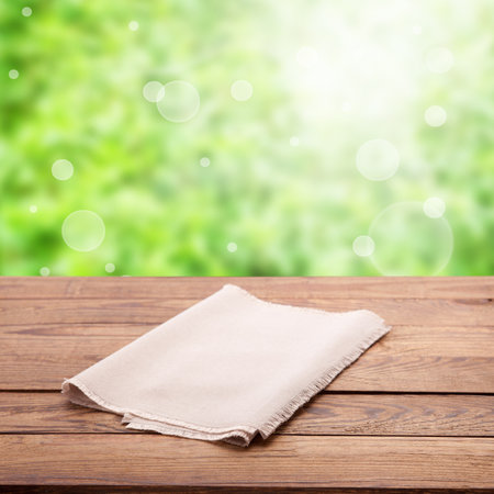 Make your product stand out with this eye-catching napkin mockup, showcasing your design against a natural wood grain. Rustic nature background on a sunny dayの写真素材