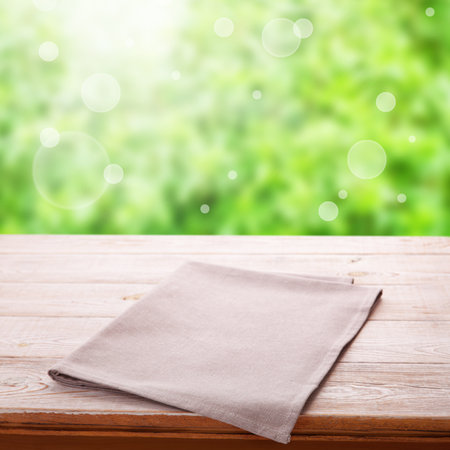 Empty white napkin on wooden table with spring background. Napkin close up top view mock up. Sophisticated Kitchen Aesthetic rustic chic background.の写真素材