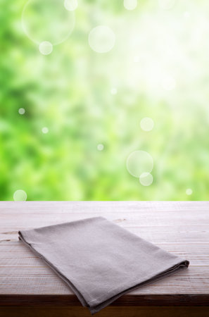 Surprise your web site visitors with this elegant rustic chic napkin on wooden table using them as a display case for items. White tablecloth front view mockup perspective.の写真素材