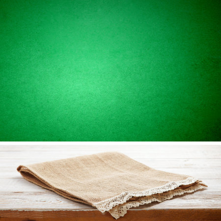 Empty canvas napkin with lace, tablecloth on wooden table and green background. Can be used for display or installation of your products. selective focusの写真素材