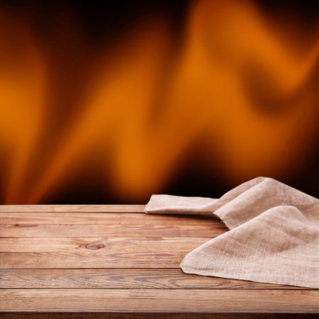 Warm and Inviting: Wooden table and Napkin for Your Next Ad Campaign. Wrinkled tablecloth front view mockup perspective.の写真素材