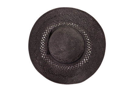 Beautiful black straw hat with ribbon and bow on white background. Beach hat top view isolatedの写真素材