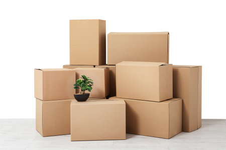 Cardboard boxes pile of brown carton box. Moving in. Stack of cardboard boxes on the flor in the empty room with copy space mockup.の写真素材