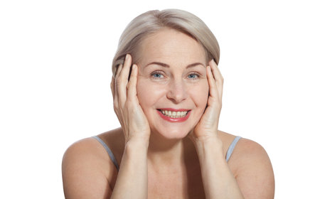 Beautiful middle-aged blonde woman shows off her perfectly well-groomed face. Macro face. Realistic images with their own imperfections.の写真素材