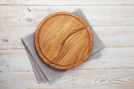Napkin and board for pizza on wooden desk.の写真素材