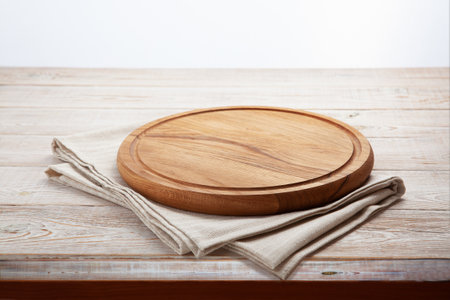 Empty pizza board and napkin on white wooden.の写真素材