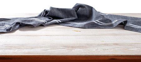 Wooden table with tablecloth, napkin. Kitchen background.の写真素材