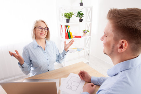 The realtor and the client have a meeting in the office for discussion.の写真素材