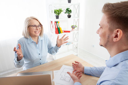 There is interaction with the client in the financial consultants office.の写真素材