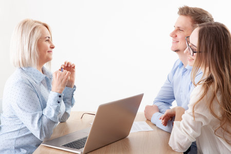 Snapshot featuring business partners discussing documents and ideas at a meetingの写真素材