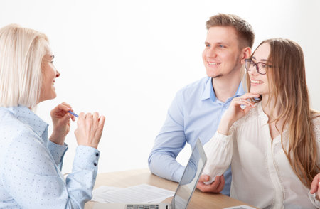 Attractive aged businesswoman, mentor coach, speaking to young people, senior woman instructing the audience at a training seminar, female business leader speaking at a meetingの写真素材