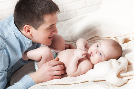 baby with dad. family, parenthood and people concept - father with little baby at homeの写真素材