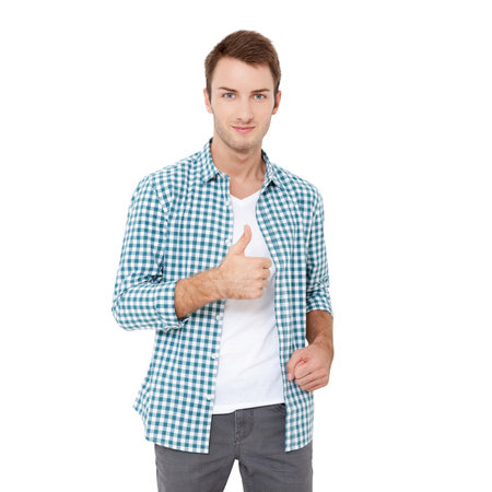 Young smiling handsome worker in formal clothing demonstrating thumb up against white backgroundの写真素材