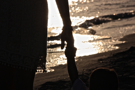 Walking along the beachの写真素材