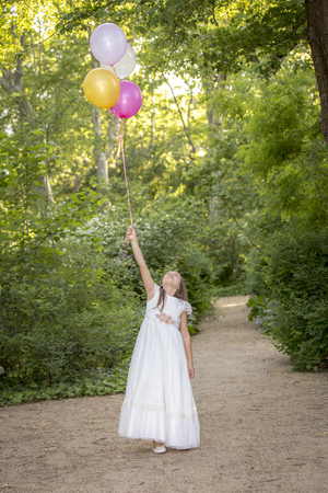 Girls of communion in a park in Madrid, Spainの写真素材