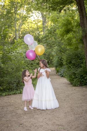Girls of communion in a park in Madrid, Spainの写真素材
