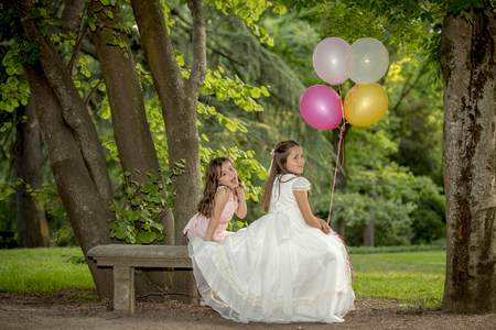 Girls of communion in a park in Madrid, Spainの写真素材