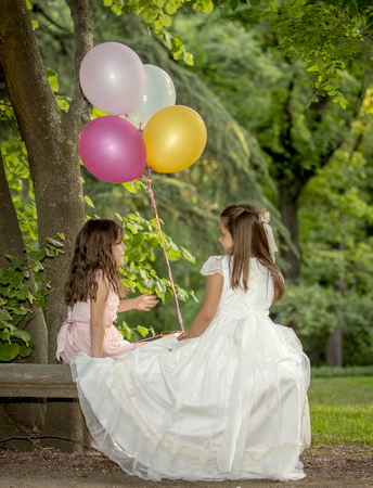 Girls of communion in a park in Madrid, Spainの写真素材