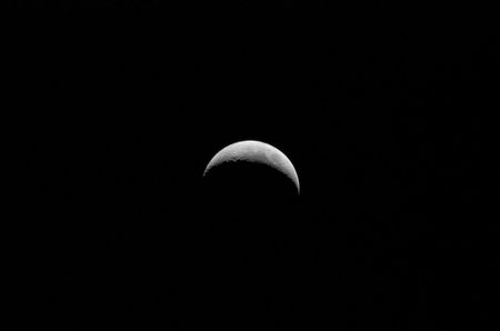 The moon in the night sky. Close-up. Black background.の写真素材