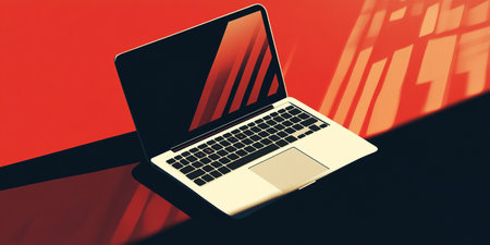 Laptop on the table with red background. 3d rendering.の素材