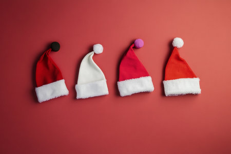 Santa Claus hats on red background. Christmas and New Year concept.の素材