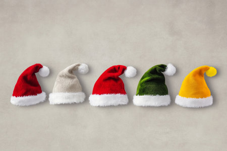 Santa Claus hats on gray background. Christmas and new year concept.の素材
