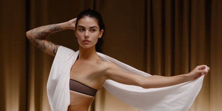 Young beautiful woman in underwear with a white shawl in her handsの素材