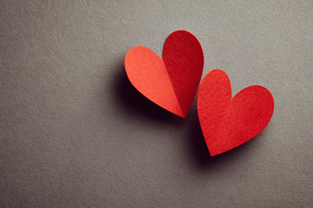 Two red paper hearts on gray background. Valentines day concept.の素材