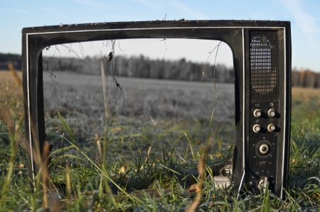 old black and white tv broken in the field, concept of retro and modern, outdoor shotの写真素材