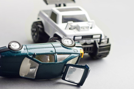 toy cars crashed, concept of a danger on a road. Studio shot on grey.の写真素材