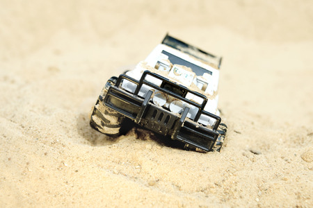 Toy off road vehicle  stucked in a desert, outdoor shot with particular focusの写真素材