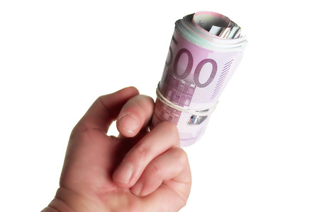 Close up of a bad gesture with a roll of euros on a middle finger, isolated on whiteの写真素材