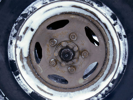 Close up of the wheel in snow, driving in a bad weather concept