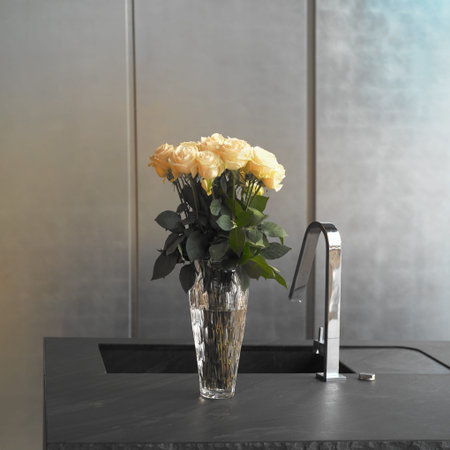 Kitchen sink and vase with roses, square interior shotの写真素材