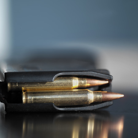 Loaded gun clip bullets in automatic clip, close up with shallow depth of fieldの写真素材