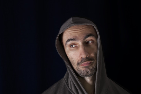 Portrait of a man looking embarrassed or religious, studio shotの写真素材