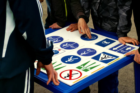 Group of teenagers learning traffic rules, outdoor horizontal shot