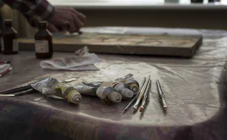 Artist working in his studio indoor shot with selective focus in the foregroundの写真素材