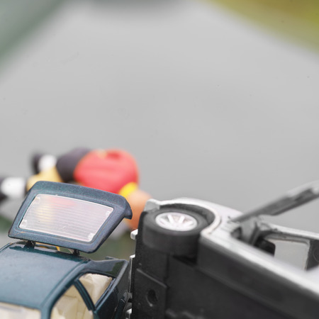 Toy cars smashed in the foreground, road and victim in the blurred backgroundの写真素材