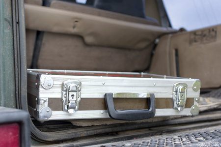 Abandoned flight case in the car boot, closeup angled shot with selective focus